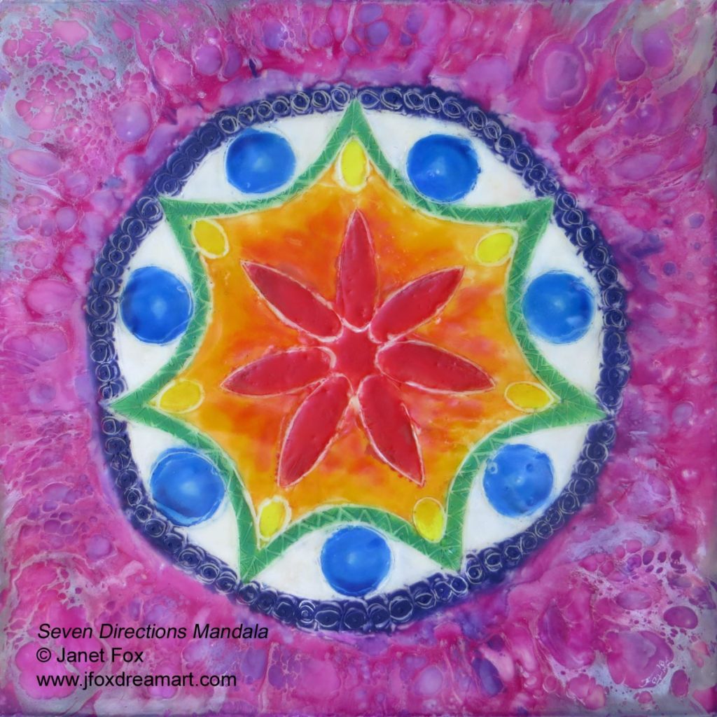 An encaustic mandala painting "Seven Directions Mandala" by Janet Fox with rainbow colors