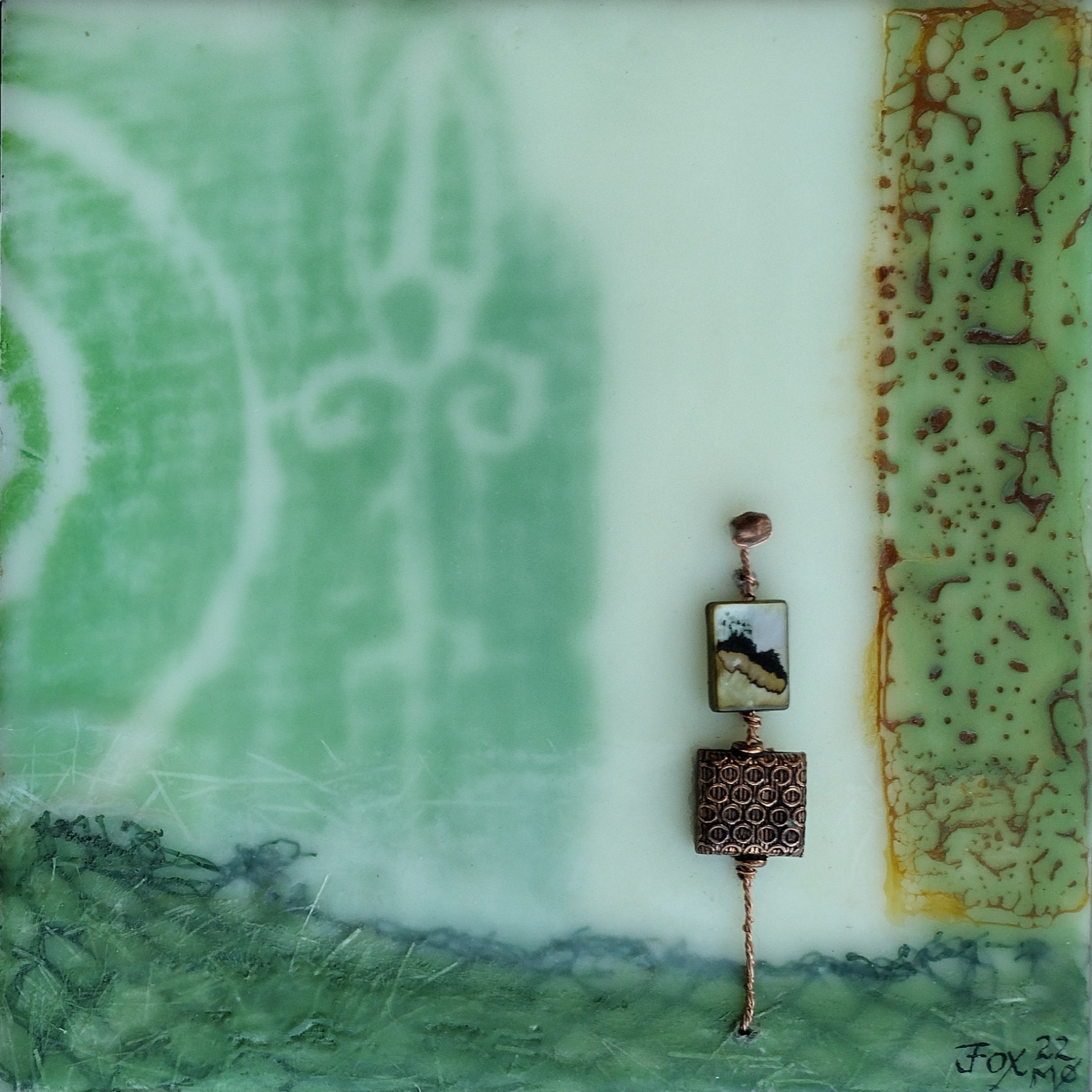 encaustic mixed media painting with green Scottish rune rubbing background and copper and green beads by Janet Fox