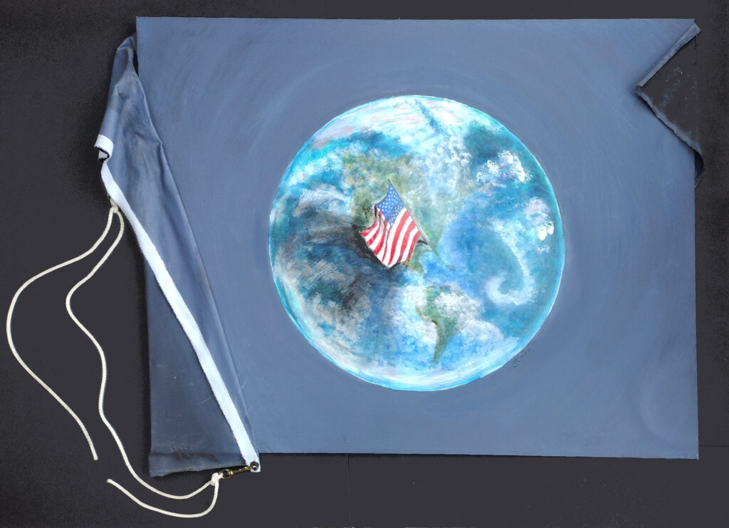 artwork titled Perspectives by Janet Fox of replica earth flag painted with acrylic on canvas with flag rope and snaps and US flag